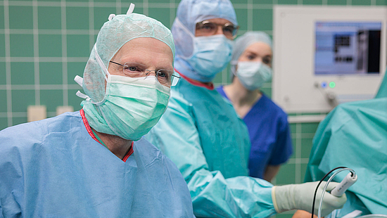 Die Grafik zeigt Prof. Dr. Helmut Lill und Oberarzt Michael Renner bei einer Operation